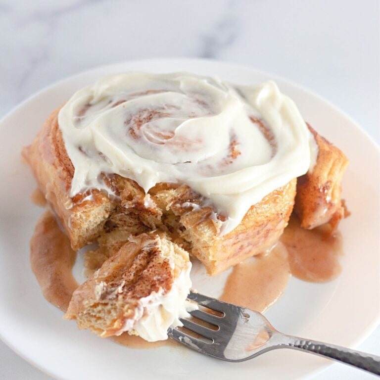 Featured image of TikTok cinnamon rolls in a pan with cream cheese frosting.