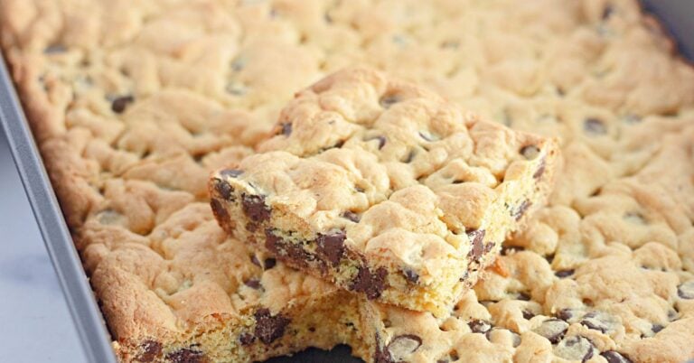 Baked chocolate chip cookie bars cooling in pan.
