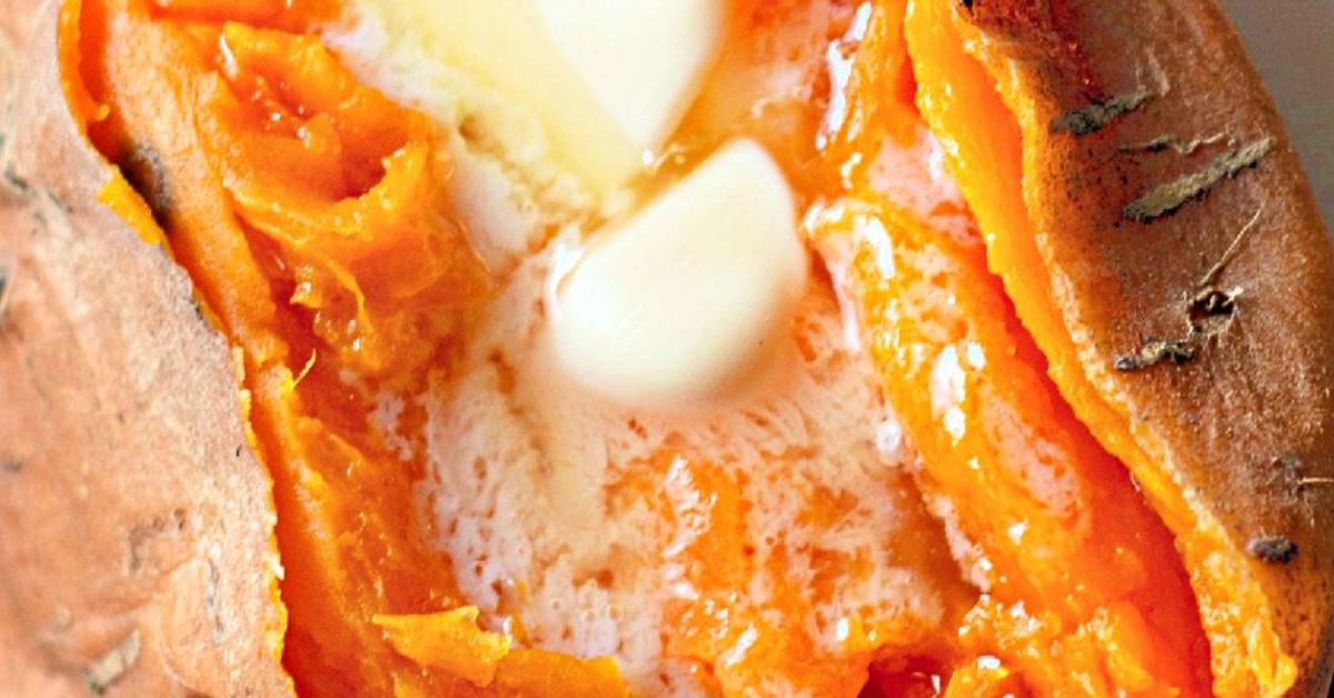 A cooked sweet potato closeup, with butter and brown sugar