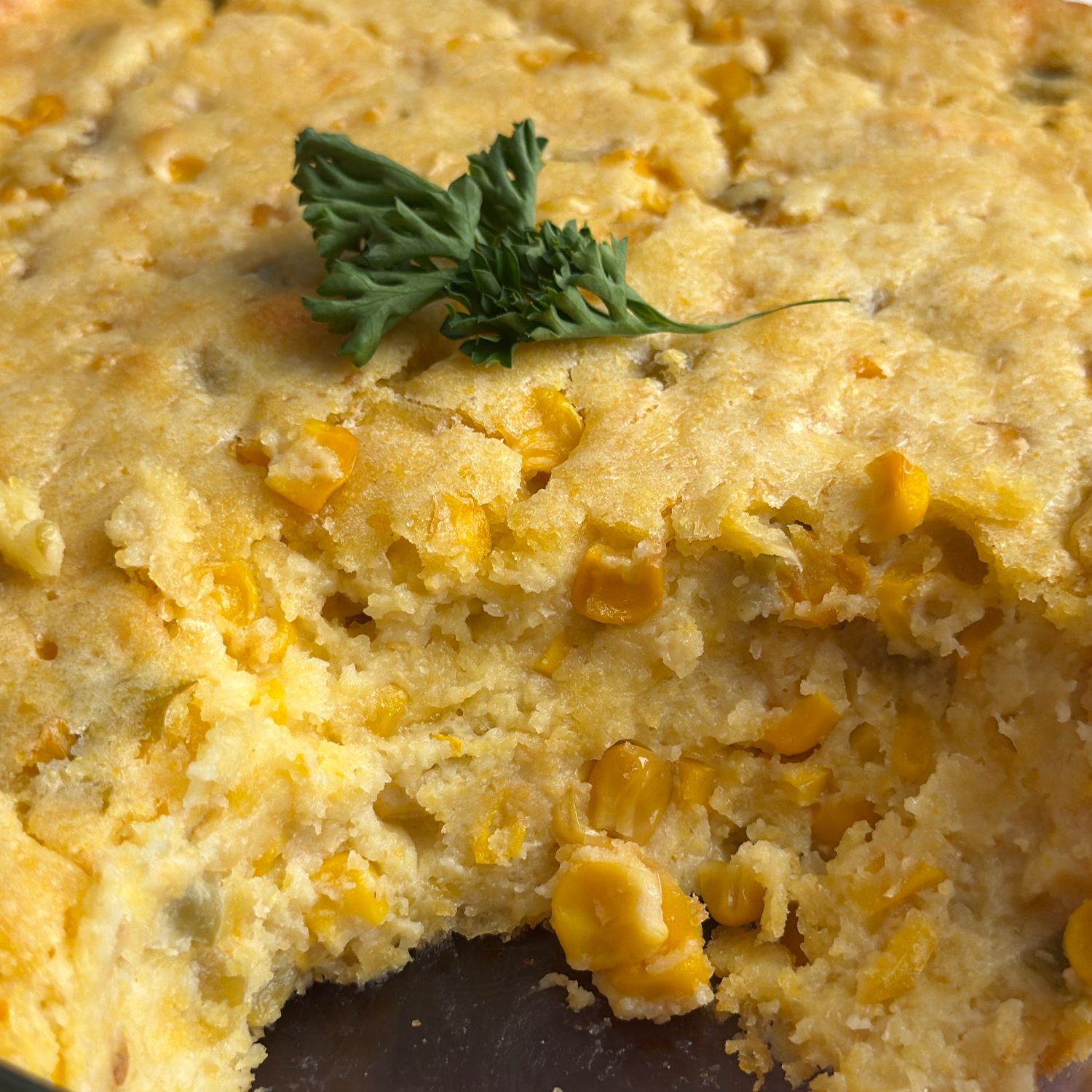 Closeup of Jiffy corn casserole in the pan with a slice taken out