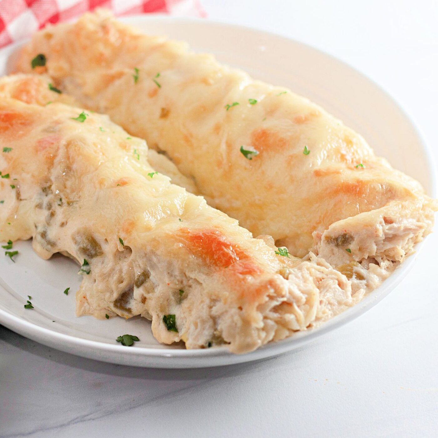 Creamy White Chicken Enchiladas with Green Chile Sauce