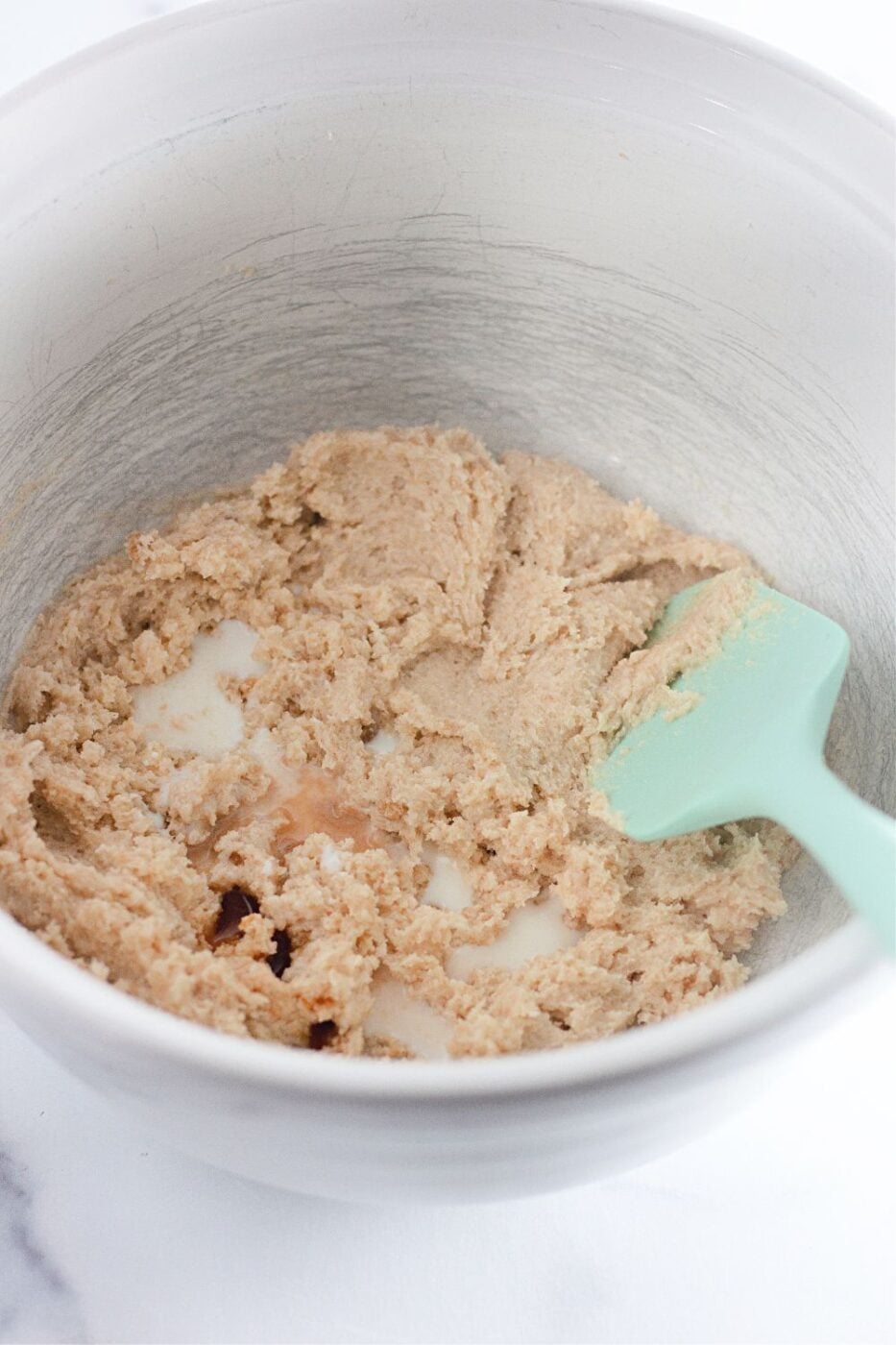 Milk, vanilla, and salt mixed into the creamed butter and sugar.