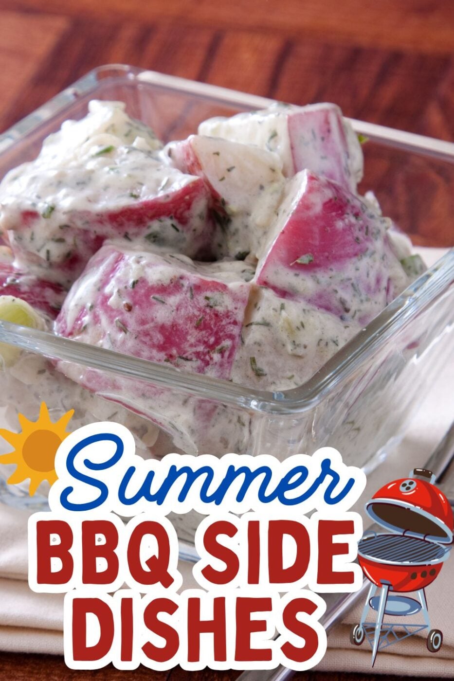 A bowl of creamy red potato salad with fresh herbs, ready to serve.
