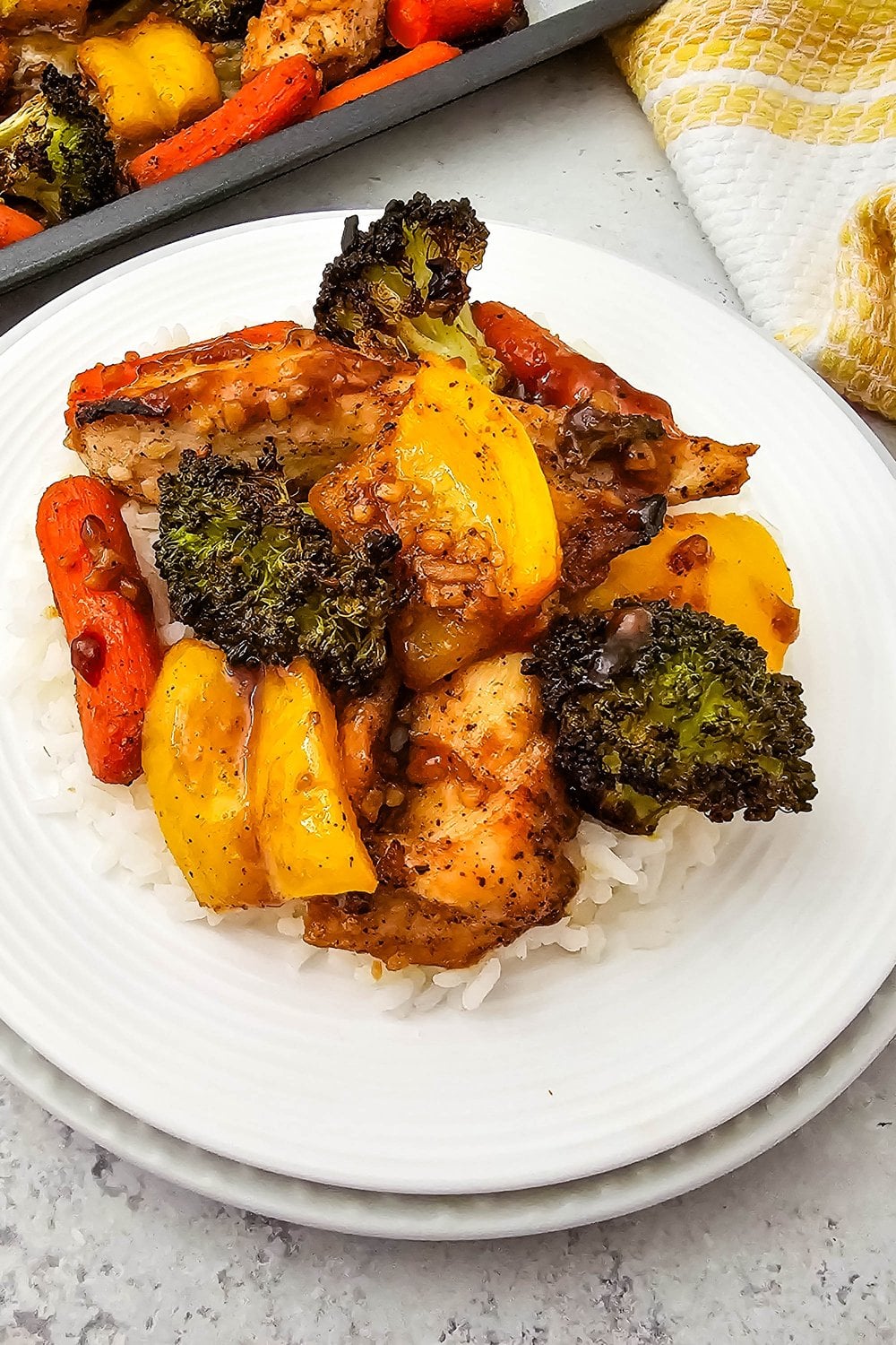 Honey garlic chicken with broccoli and carrots served over rice