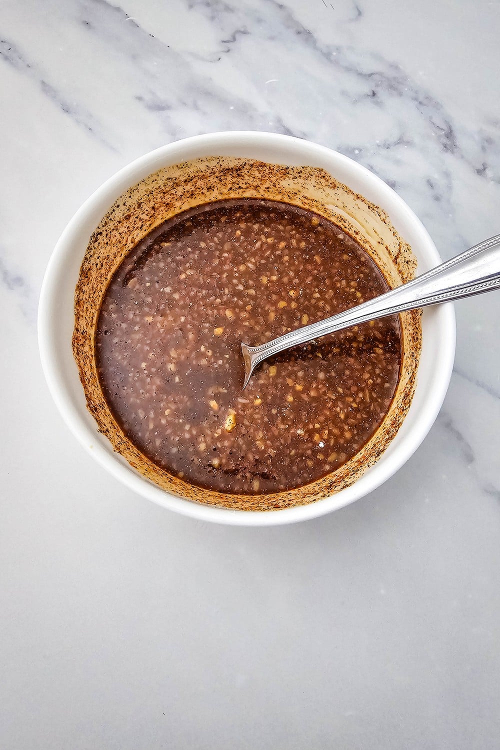 Honey garlic sauce with soy sauce, honey, garlic, and spices mixed together in a bowl