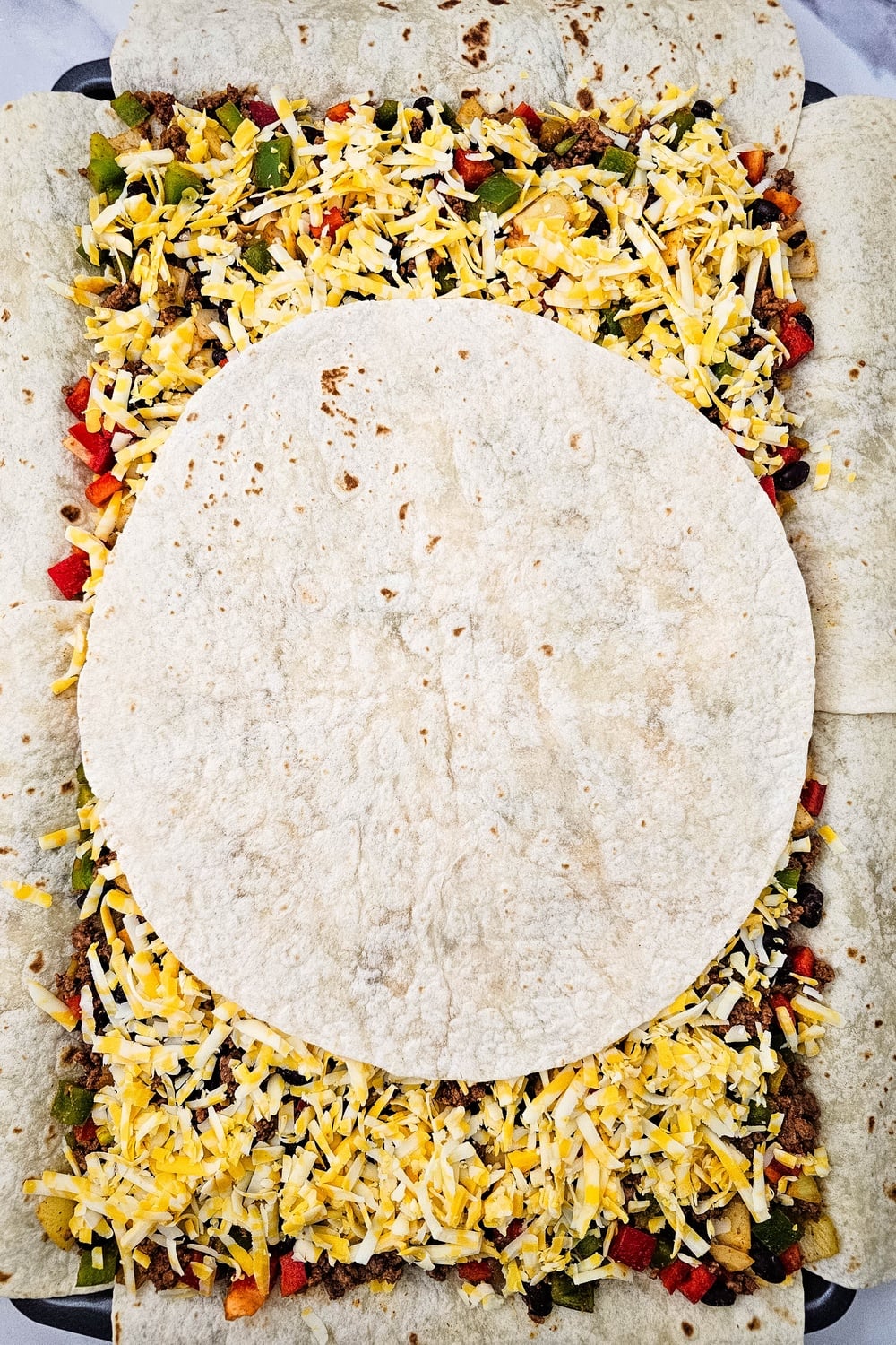 Final tortilla placed in the center over the filling