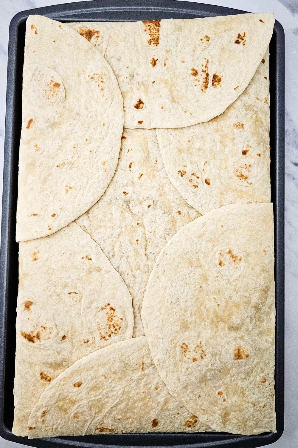 Tortillas folded inward to fully enclose the filling