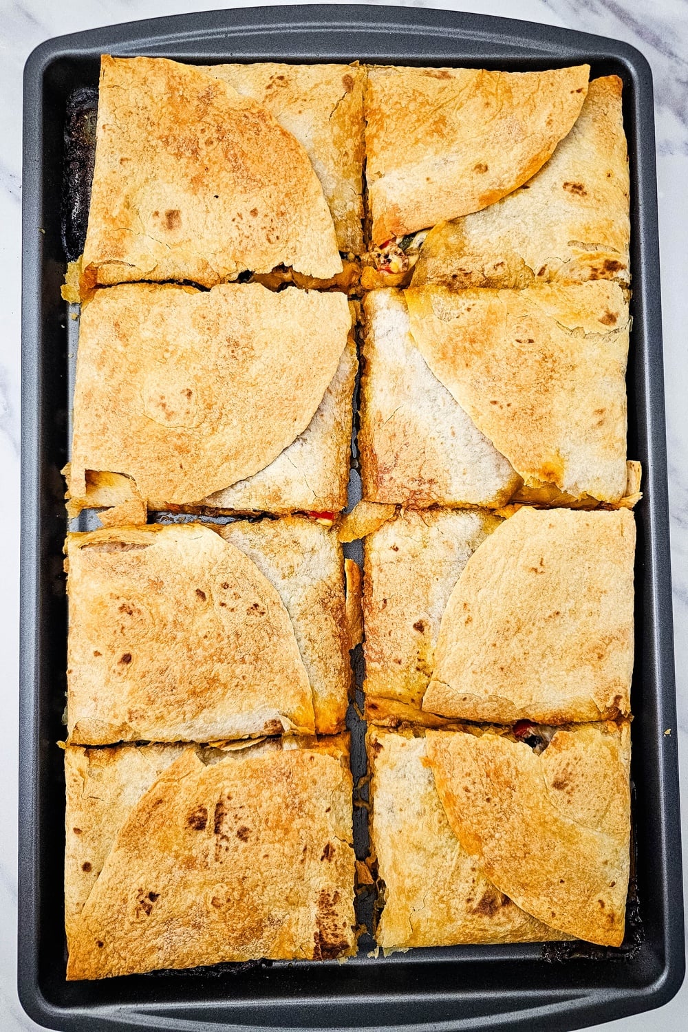 Sheet pan tex mex quesadillas cut into squares ready to serve