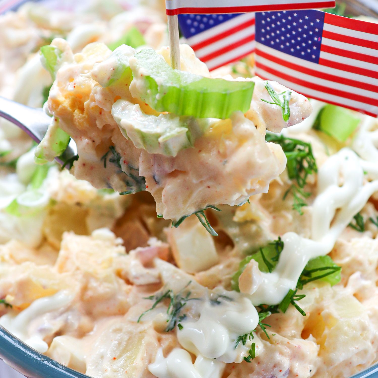 Closeup of potato salad with American flag picks
