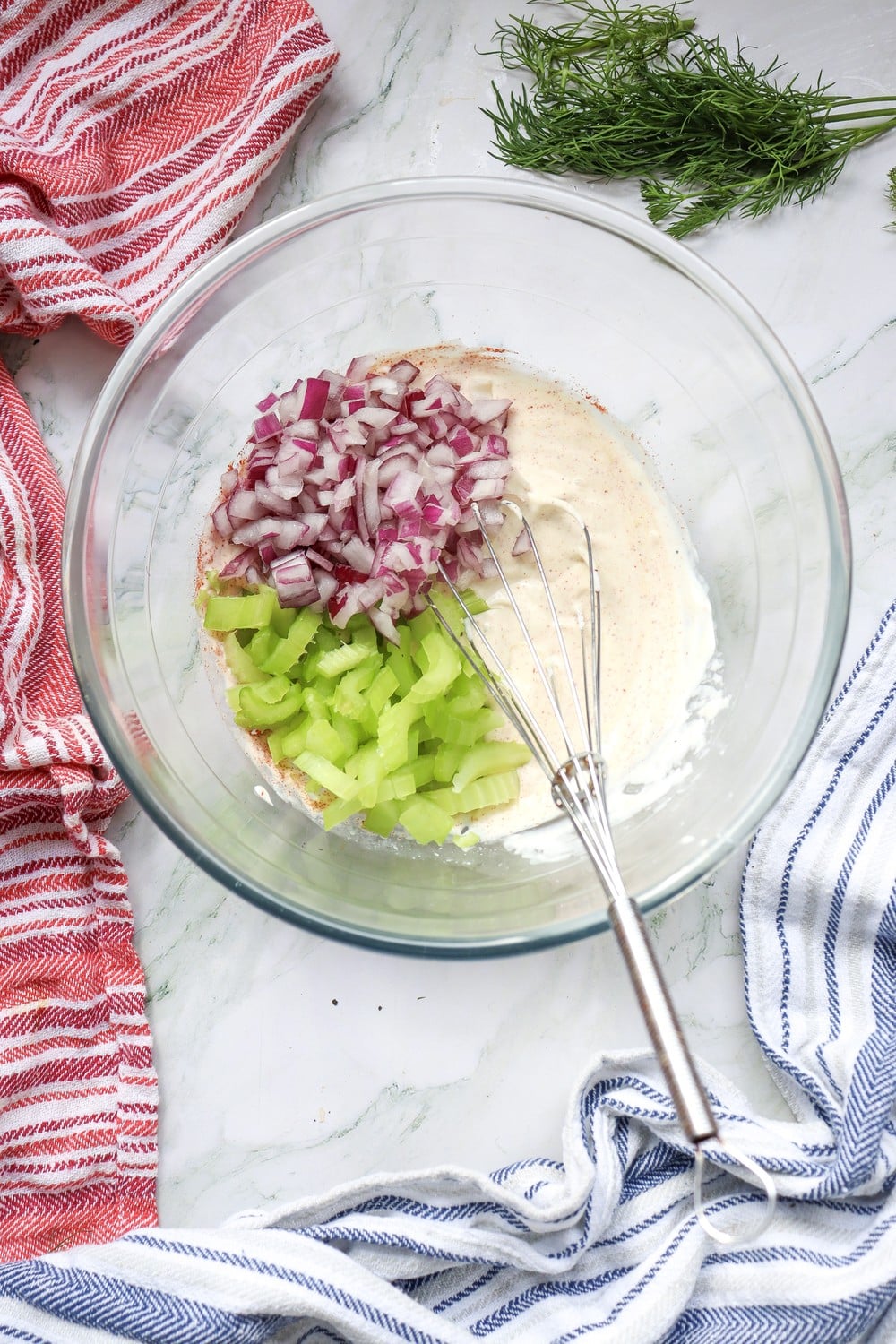 Chopped celery and red onion folded into the creamy dressing for 4th of July potato salad