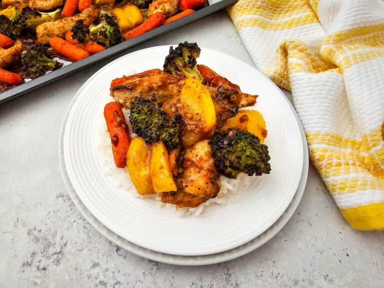 Closeup of a plate of honey garlic chicken and veggies on a white plate