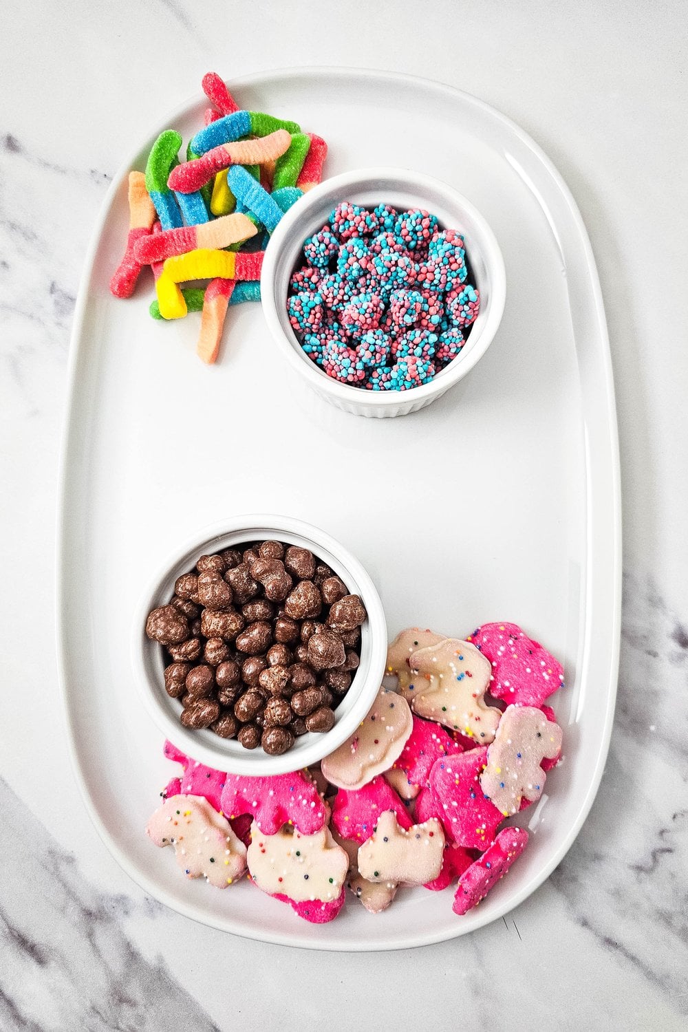 Sour gummy worms placed on the kids birthday charcuterie board