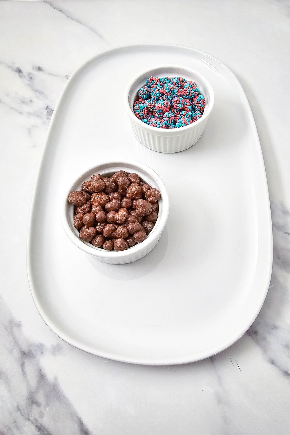 Both ramekins placed on the oval platter