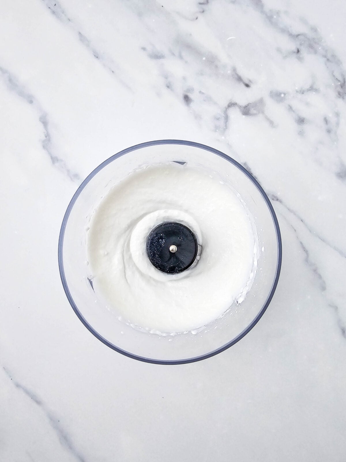 Cottage cheese blended completely smooth in the food processor bowl
