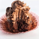 Homemade frosted chocolate cupcake with a bite taken out of it