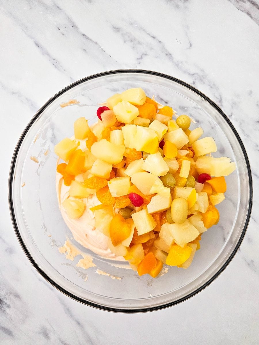 Drained fruit added to the creamy orange base
