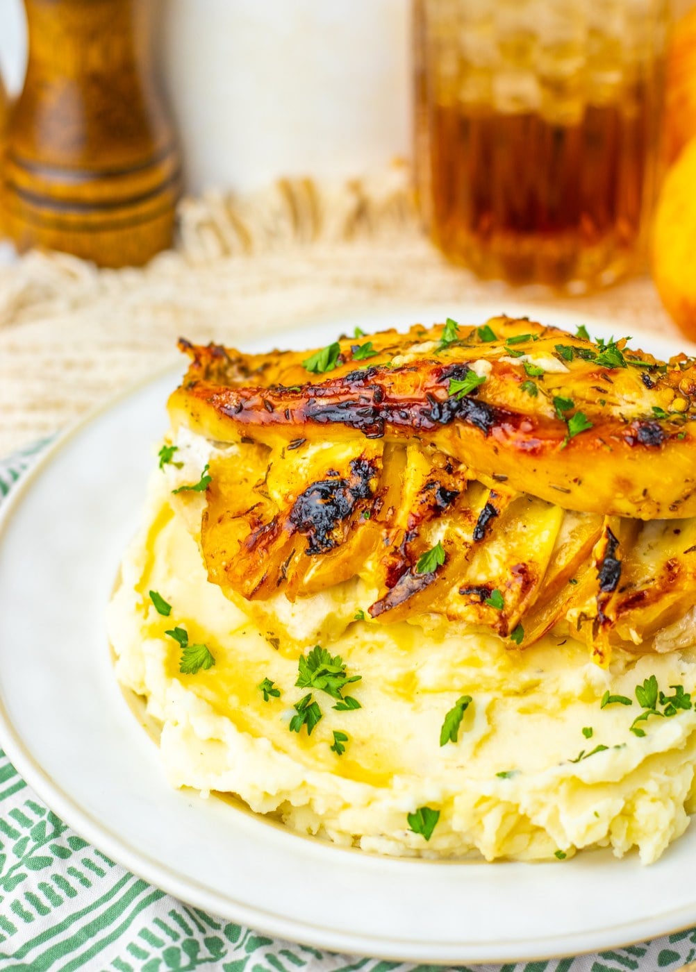 Apple and brie stuffed chicken breasts with maple glaze over mashed potatoes