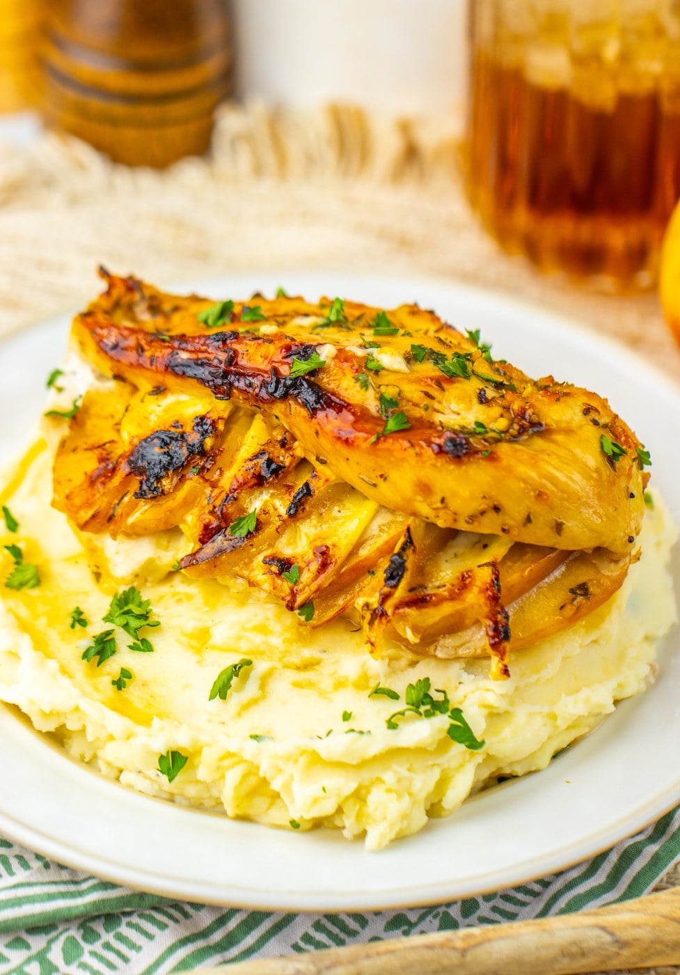 Apple and brie stuffed chicken with maple glaze served over mashed potatoes