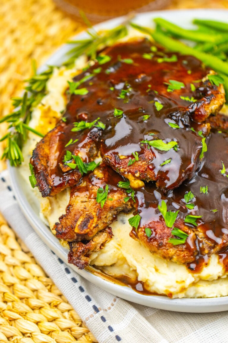 Apple cider glazed pork chops served over mashed potatoes with green beans
