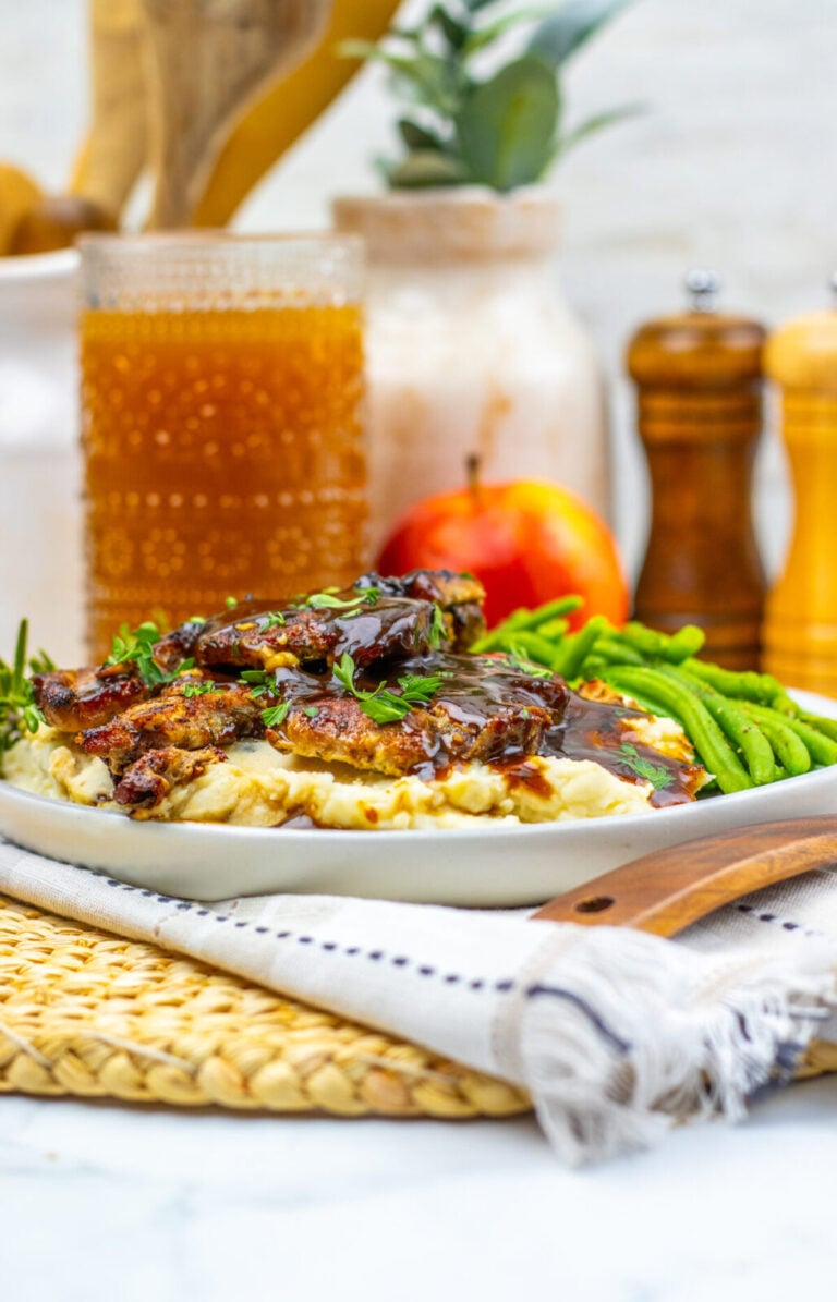 Apple cider glazed pork chops over creamy mashed potatoes