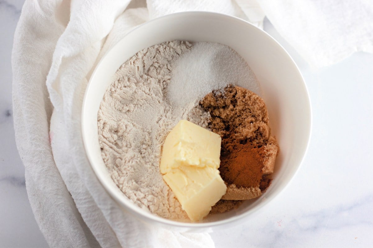 Apple cinnamon muffins cutting in butter