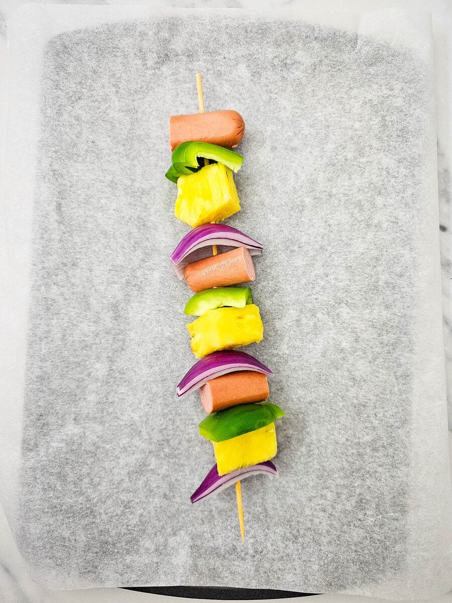 A fully assembled hot dog kabob skewer ready to grill