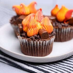 Single campfire cupcake topped with red, orange, and yellow buttercream flames
