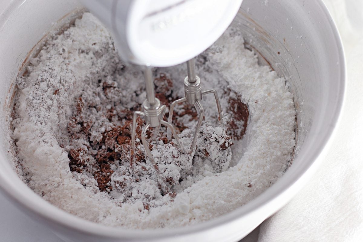 Chocolate buttercream frosting being beaten in a bowl