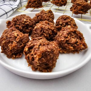Chocolate peanut butter no-bake cookies arranged on a round white serving plate.