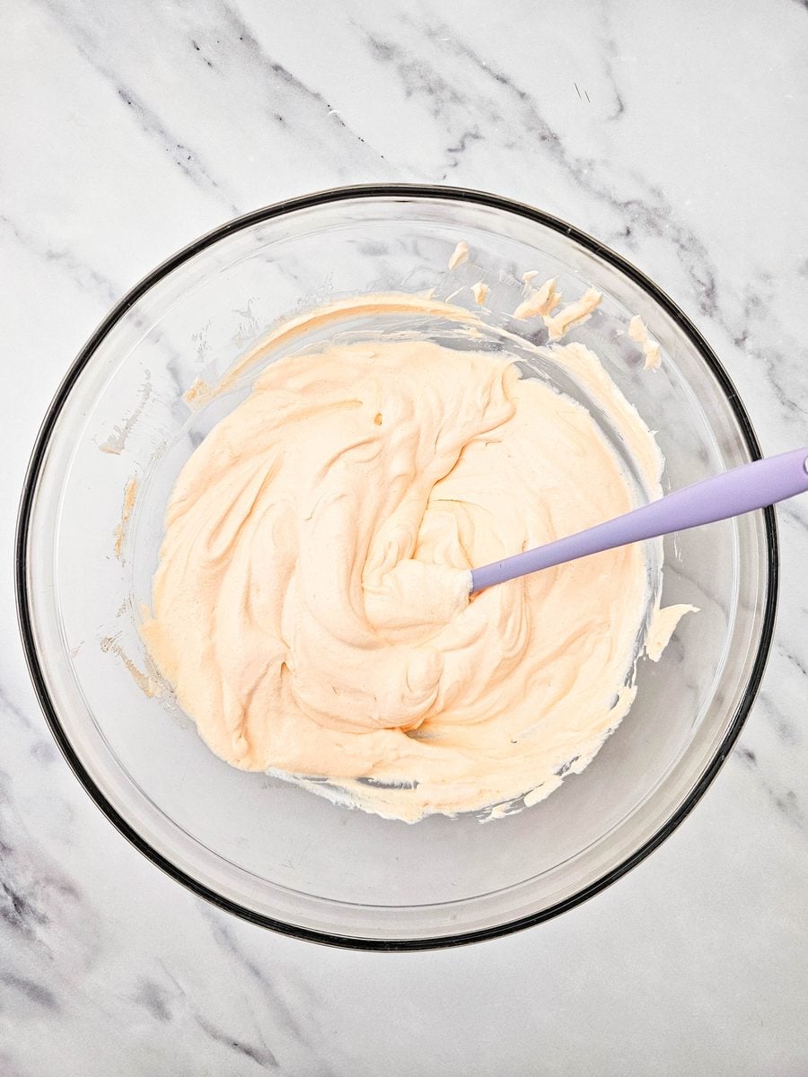 Sour cream and orange gelatin whisked into a creamy orange base
