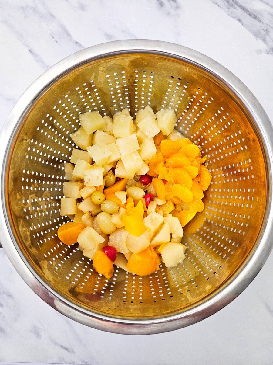 Canned fruit draining in a colander