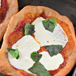 Personal fried pizza topped with tomato sauce, fresh mozzarella, and basil
