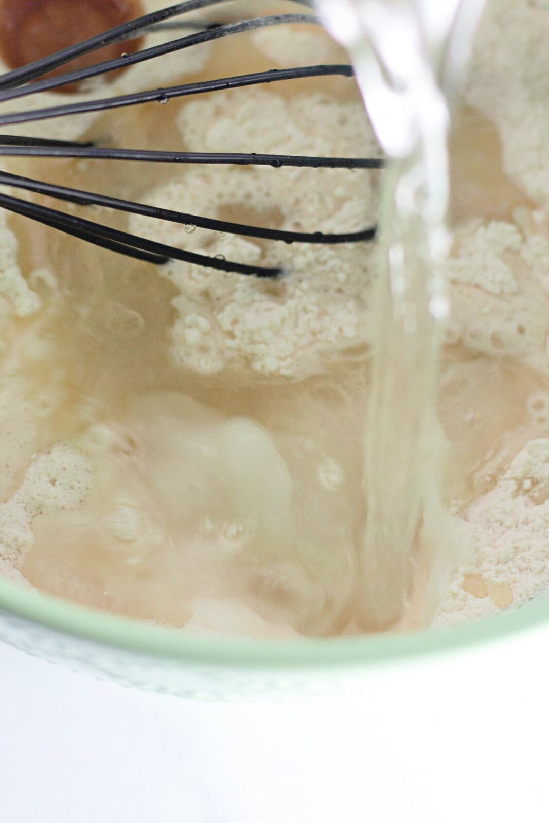 Adding cold water to the funfetti crazy cake batter