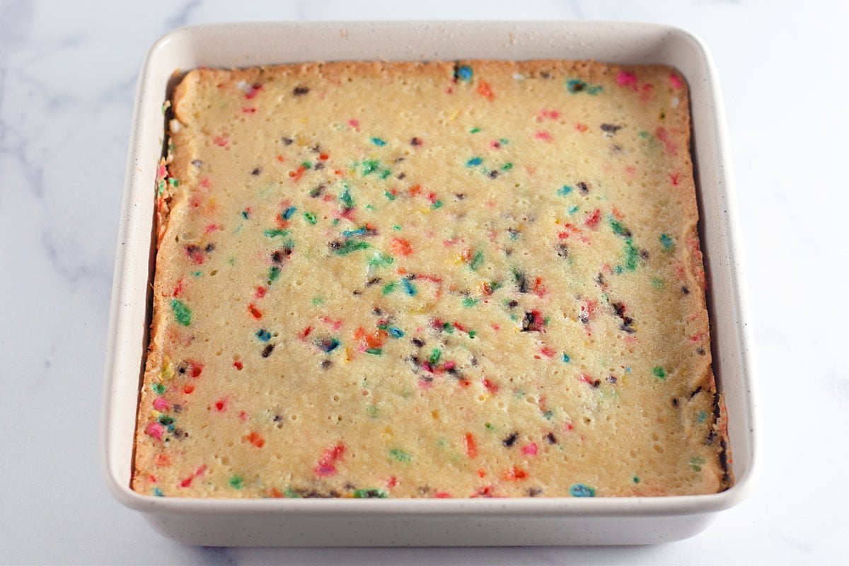 Baked funfetti crazy cake cooling in the pan