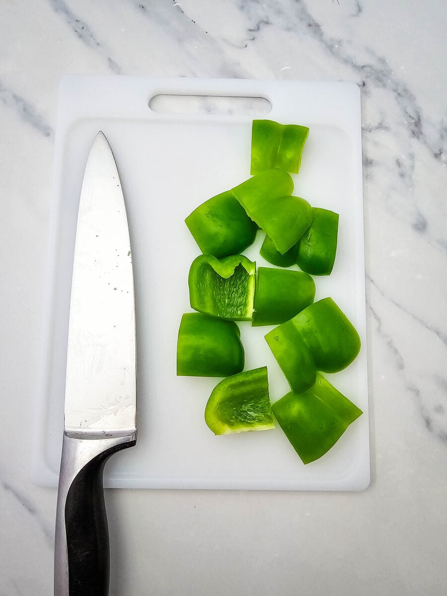 Green bell pepper cut into pieces for hot dog kabobs