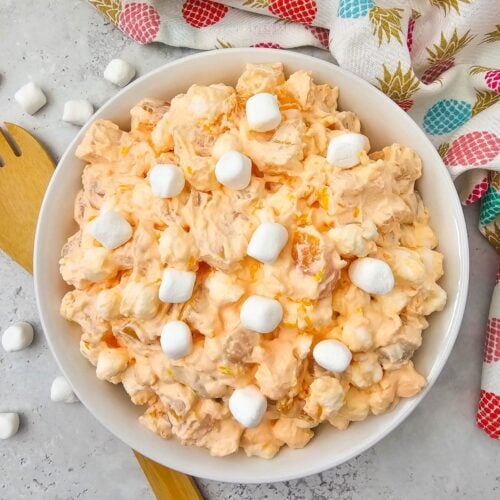 Bowl of Hawaiian fruit salad with mini marshmallows and a pineapple napkin