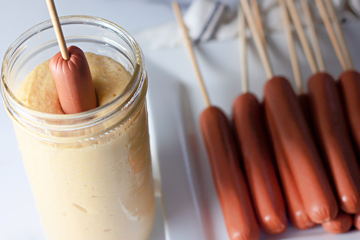 Hot dog on a stick coated in corn dog batter