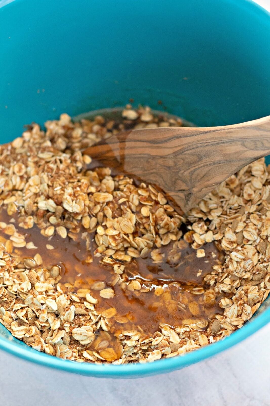 homemade cranberry granola spreading on baking sheet