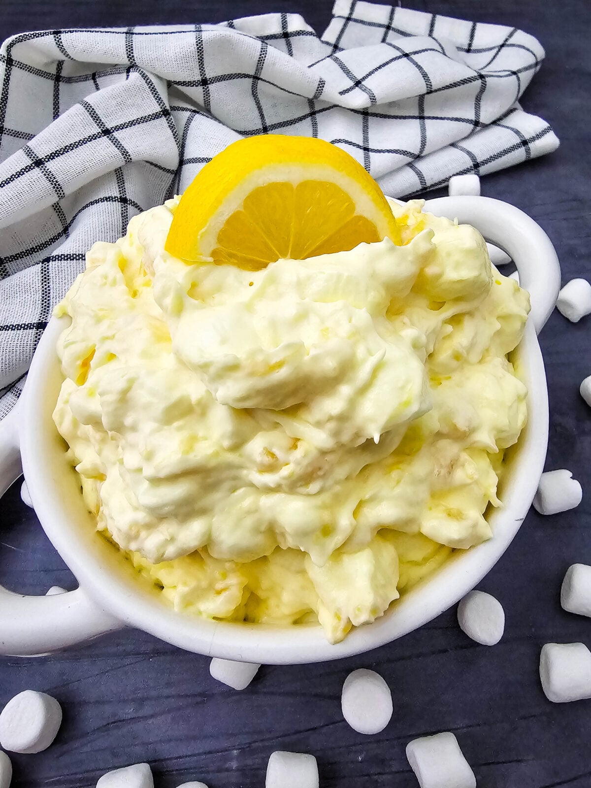 Lemon fluff salad served in a bowl with coconut garnish