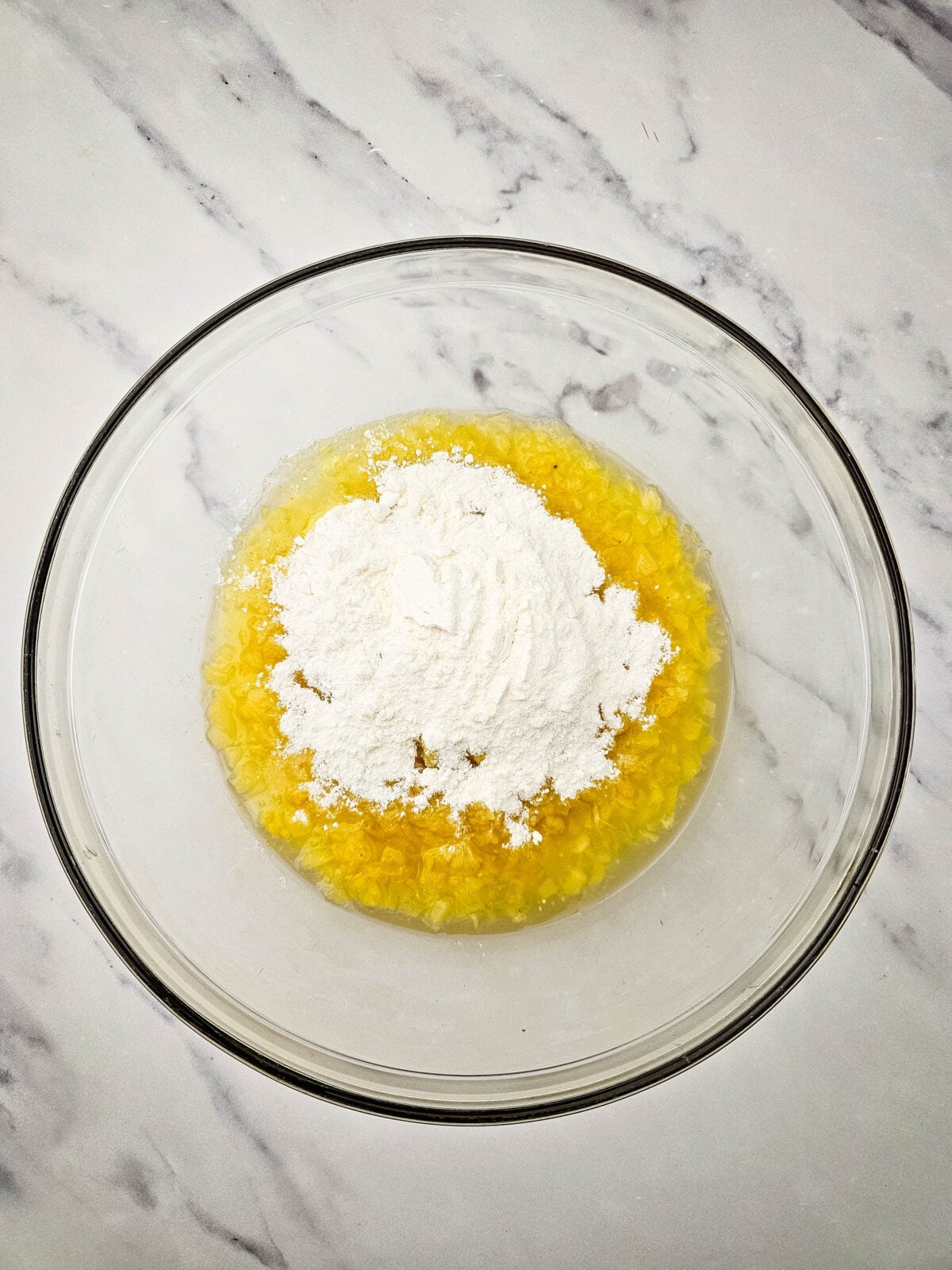 Combining crushed pineapple and lemon pudding mix in a large bowl