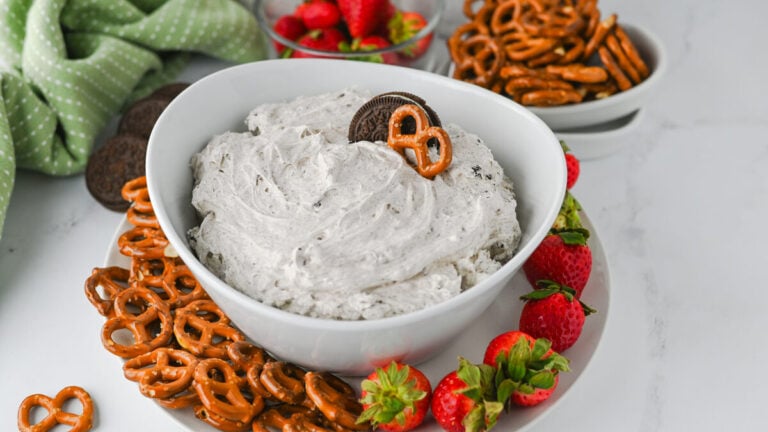 Easy Oreo dip in a white bowl with pretzels and strawberries