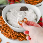 Pretzel pulling Oreo dip from the bowl