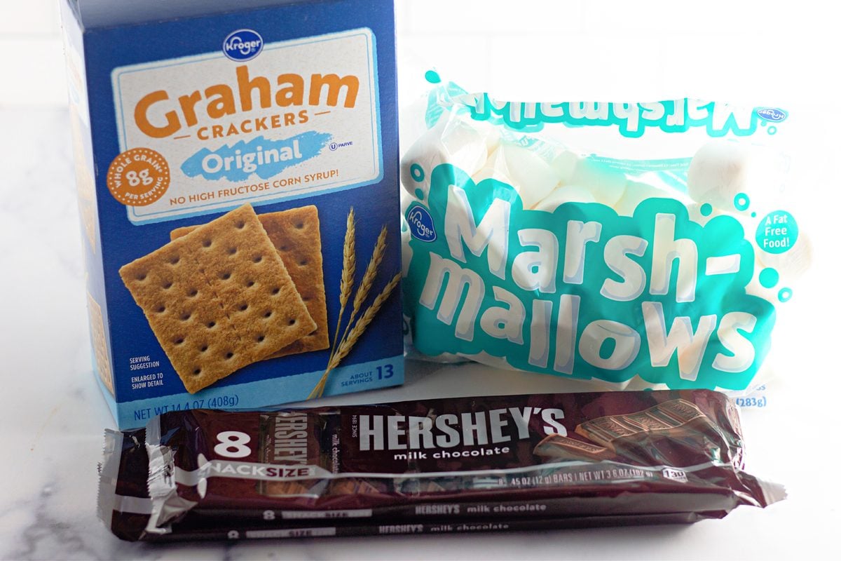 Graham crackers, marshmallows, and Hershey's chocolate bars on a counter