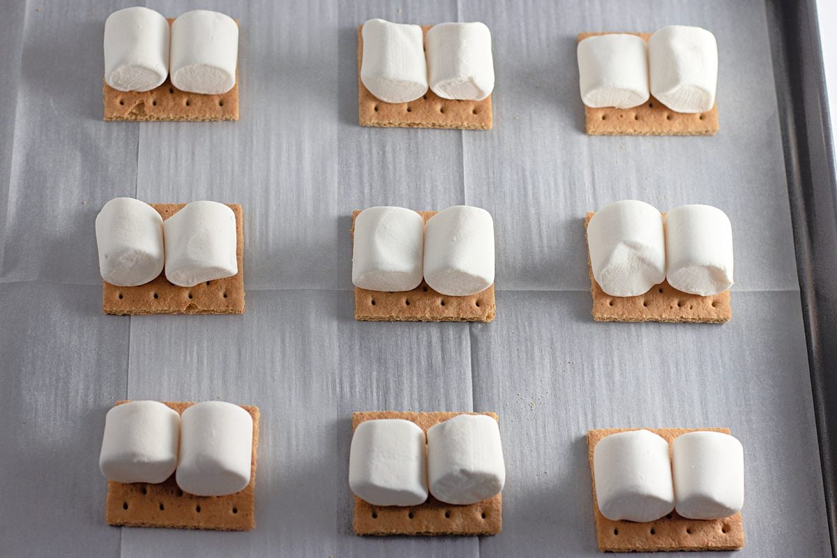 Two marshmallows placed on each graham cracker square