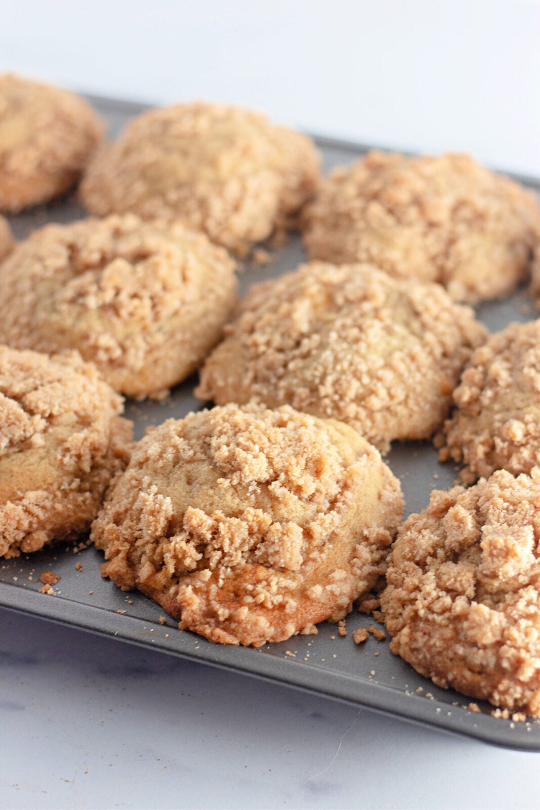 Peach streusel muffins cooling