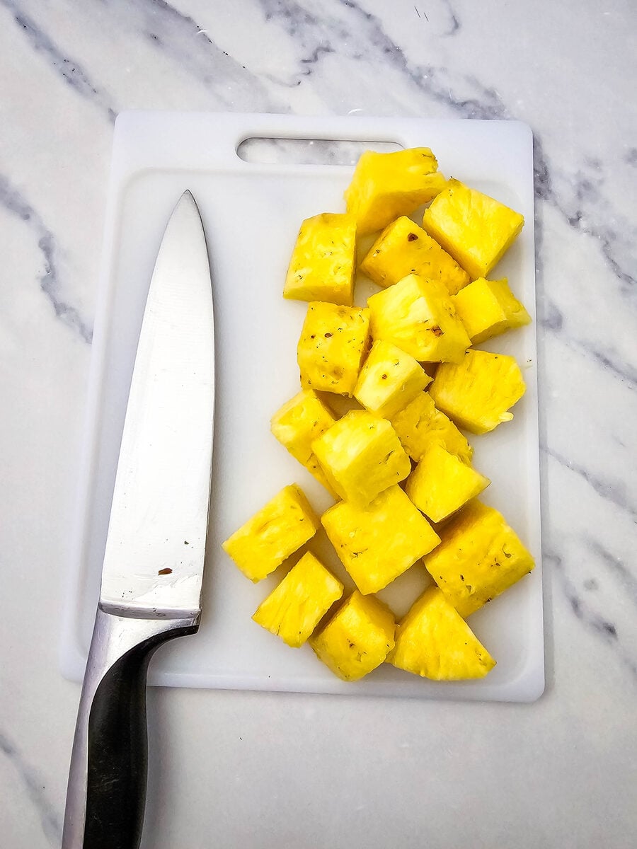 Fresh pineapple cut into chunks for hot dog kabobs