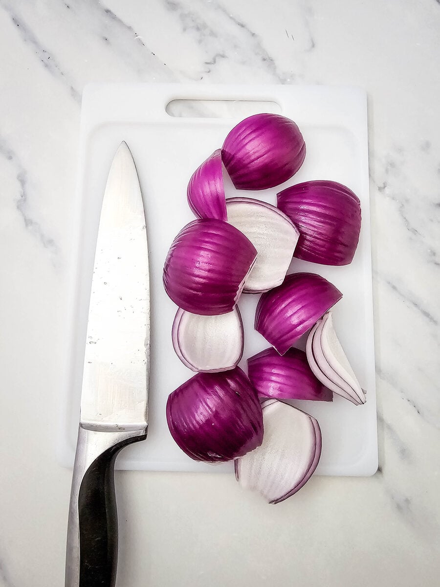 Red onion cut into wedges for hot dog kabobs