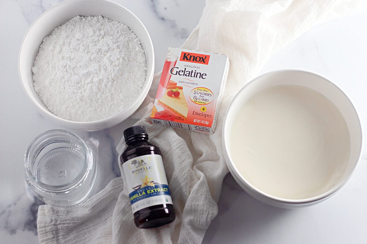 Ingredients for stabilized whipped cream: unflavored gelatin, heavy whipping cream, powdered sugar, and vanilla extract