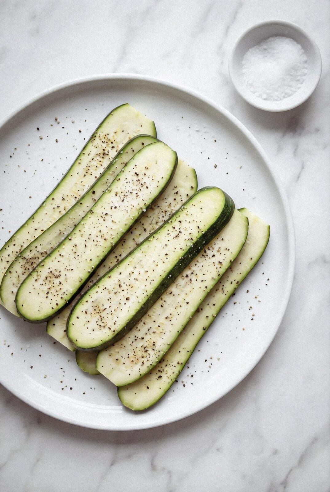 Thinly sliced zucchini strips seasoned with salt and pepper