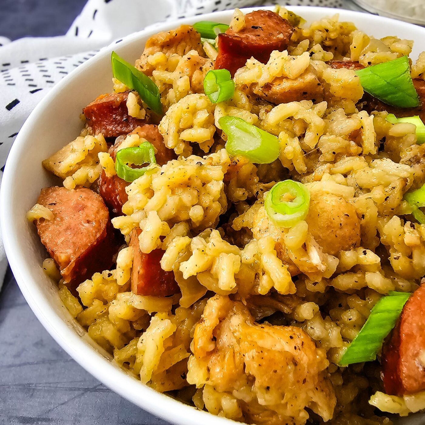 Closeup of brown jambalaya (no tomatoes) in a white bowl